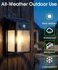 Outdoor Solar Porch Lights 2 Pack Featuring Motion Sensor And 3 Lighting Modes Zero Wiring Hassle Built Tough Weatherproof Wall Lanterns Sconces For Front Door Garage Fence Patio 7 5 Inch illuminated in rain on wooden post.