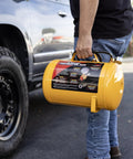 Person holding a Grab And Go 5 Gallon Portable Air Tank With Sturdy Carry Handle And 125 Psi Max Pressure, yellow design.