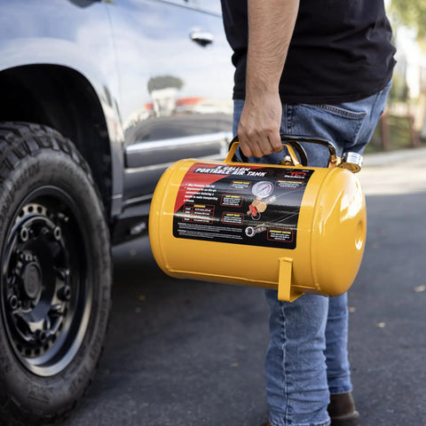 Person holding a Grab And Go 5 Gallon Portable Air Tank With Sturdy Carry Handle And 125 Psi Max Pressure, yellow design.