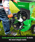 Person starting 3 In 1 Wood Chipper Shredder Mulcher MF30 Heavy Duty Gas Powered 7HP 212cc With 3 Inch Capacity, on grass.