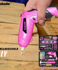 Person holding pink cordless screwdriver from Pink Tool Set For Women 130 Piece Home Toolkit With 3.6V Cordless Rechargeable Screwdriver Essential Household Tools For New Homes Apartments College Dorms DIY Projects And Everyday Fixes.
