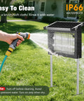 Powerful 4500V Mosquito Zapper With Panel Sensor, Waterproof Solar Bug Killer being rinsed with garden hose on grass