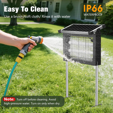 Powerful 4500V Mosquito Zapper With Panel Sensor, Waterproof Solar Bug Killer being rinsed with garden hose on grass