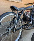 Custom bike with Beefy 26 Inch Bike Rim Wheel Set Built Tough With Double Wall Aluminum Alloy, visible against a brick wall.