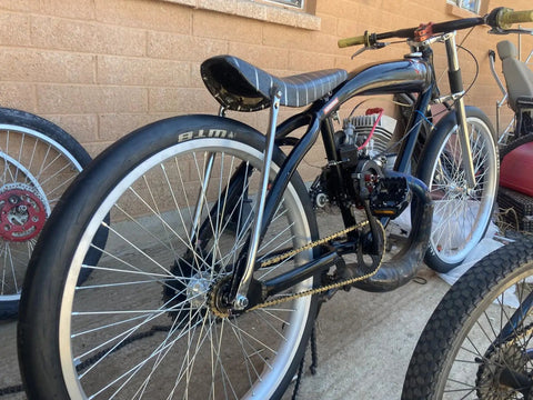 Custom bike with Beefy 26 Inch Bike Rim Wheel Set Built Tough With Double Wall Aluminum Alloy, visible against a brick wall.