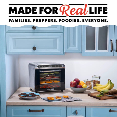 Big Time Performance Stainless Steel Digital Food Dehydrator With Eight Roomy Trays and 360 Airflow on kitchen counter with fruits.