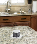 Heavy Duty Built Tough 20A Countertop Pop Up Receptacle Flush Mount Dual Power Outlet installed on a granite kitchen countertop.