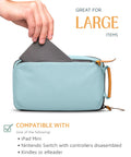 Hand placing tablet into Compact Travel Tech Organizer Bag For Cables Chargers And Gadgets With Leather Accents, Dusty Teal color