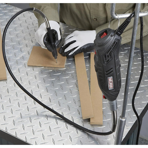 Pro Grade 107 Piece Rotary Multitool Kit With 35000 RPM Variable Speed Dial used for precision drawing on cardboard.