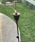 Conical Bronze Outdoor Torch Set For Backyards And Patios, Weather Resistant And Citronella Oil Compatible, lit in garden