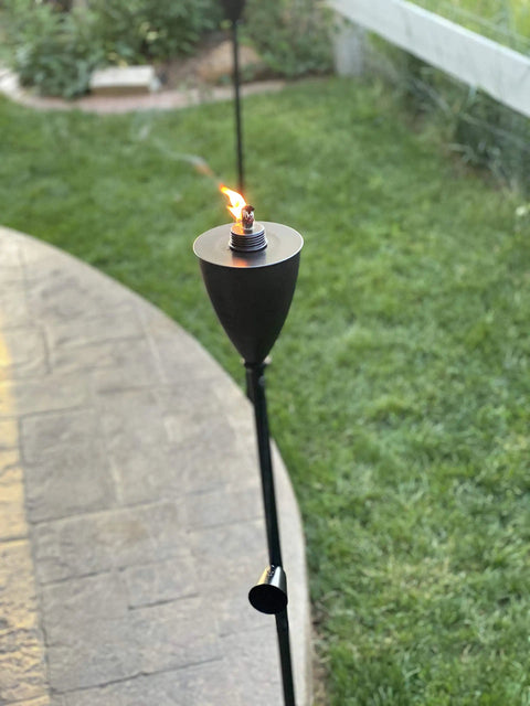 Conical Bronze Outdoor Torch Set For Backyards And Patios, Weather Resistant And Citronella Oil Compatible, lit in garden