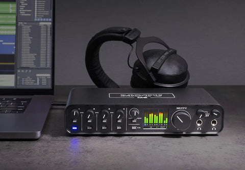 USB-C 6x4 audio interface with pro-grade studio-quality sound and ESS Sabre32 DAC, 120 dB dynamic range, on a desk with headphones