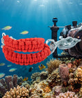 Diving Camera Lanyard With 360 Degree Retractable Rotation for Underwater Housings, shown with camera near colorful coral reef.