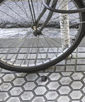 Aluminum Alloy Bicycle Axle Cap for Front and Rear Wheel Hubs Easy Install Hub Nut Replacement alongside a bike wheel on pavement