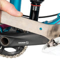 Close-up of All In One Chain Whip And Pedal Wrench For Bike Maintenance, 10.75 Inch Steel Tool in use on a bike pedal.