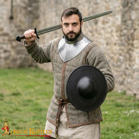 Man holding Beefy Battle Ready 11 Inch Small Medieval Buckler Shield With Rolled Rim And Riveted Grip 16 Gauge Mild Steel for LARP