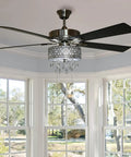 Drop Dead Gorgeous 52 Inch Crystal Chandelier Ceiling Fan With Integrated LED Lights And Smooth Airflow Featuring Satin Nickel Finish Plus K9 Hanging Crystals For Truly Top Shelf Room Makeovers in a bright room with windows.