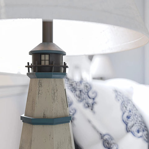 Close-up of Coastal Nantucket Table Lamp In Antique White Finish with lighthouse base and white linen shade, 31-inch tall.