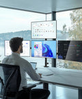 Kick Up Your Desk Game With This Stacked Quad Monitor Mount For 13 To 27 Inch Led Lcd Screens Holding 22 Pounds Per Arm And Keeping Things Clean A Real Space Saving Flex Right Now, showing a professional using four monitors.