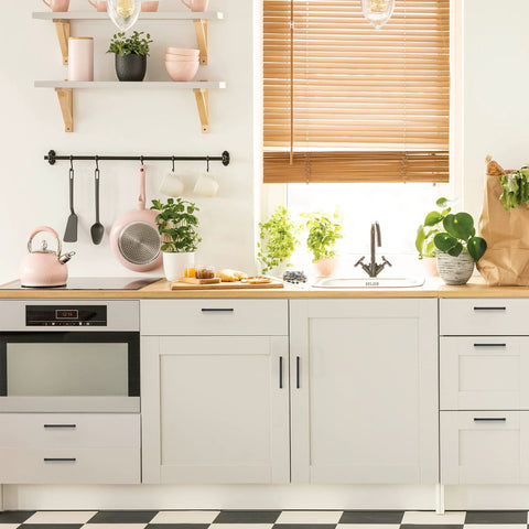 Modern kitchen with white cabinets featuring 30 pack matte black cabinet pulls with five inch center to center holes, sleek design