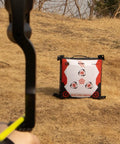 Durable Portable Bag Archery Target 40x40 with high density core placed on dry grass for outdoor practice with bow