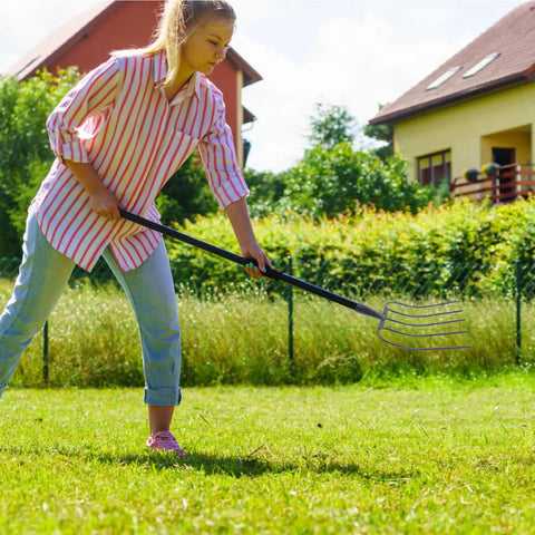 Person using Heavy Duty Stainless Steel Hand Fork For Gardening And Farming, Easy Weeding And Digging, on grass in backyard.