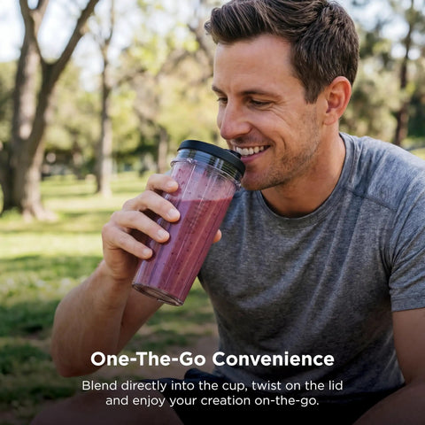 Heavy Duty Personal Blender Featuring 900W Push To Blend Motor And Pro Extractor Blades Crushing Ice For Nutrient Dense Smoothies Including Three Grab And Go 20 Oz Serveware Cups In Classic Silver, man enjoying a smoothie outdoors.