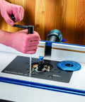 Using a wrench on the Premium Shop Grade Mid Size Router Lift Kit Featuring Rock Solid Phenolic Table Plate.