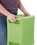 Person holding Built Tough 3 Level Work And Garden Seat With Flip Heights at 9, 12 And 15 Inches, one-piece weatherproof construction, green.