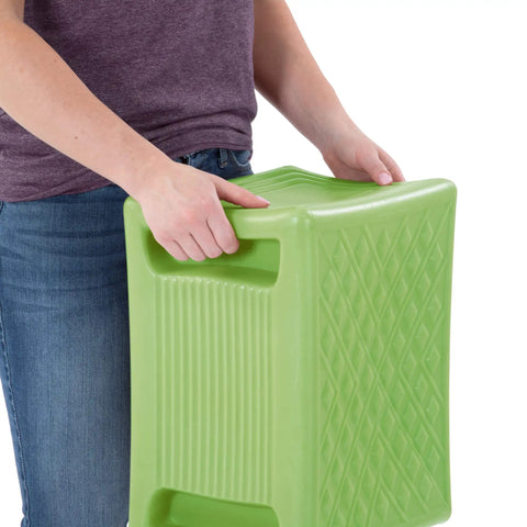 Person holding Built Tough 3 Level Work And Garden Seat With Flip Heights at 9, 12 And 15 Inches, one-piece weatherproof construction, green.