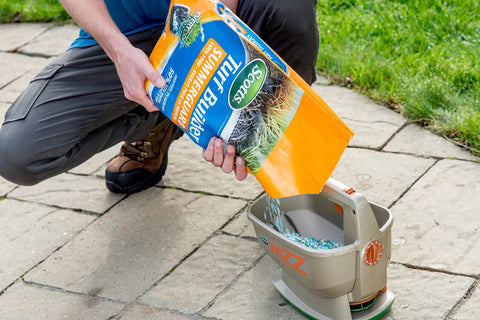 Person using No Crank One Touch Battery Powered Spreader for Fertilizer Seed and Ice Handheld Spreader with EdgeGuard Tech