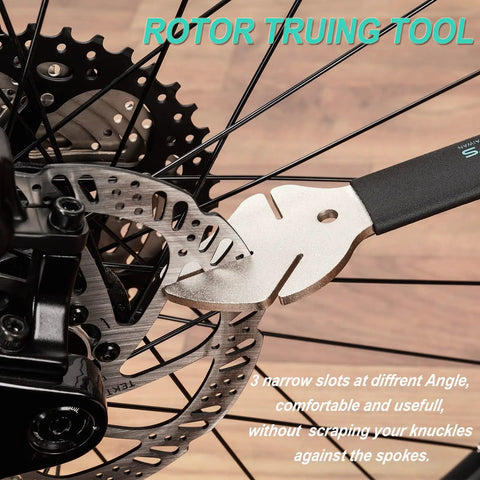 Rotor Truing Fork 2 In 1 Bike Rotor Tool And Hydraulic Piston Press For Bicycle Disc Brakes shown in use on a bike wheel.