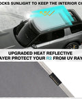 Custom Foldable Roof Sunshade For Rivian R2 Gray Heat Reflective Cover on vehicle windshield blocking sunlight.