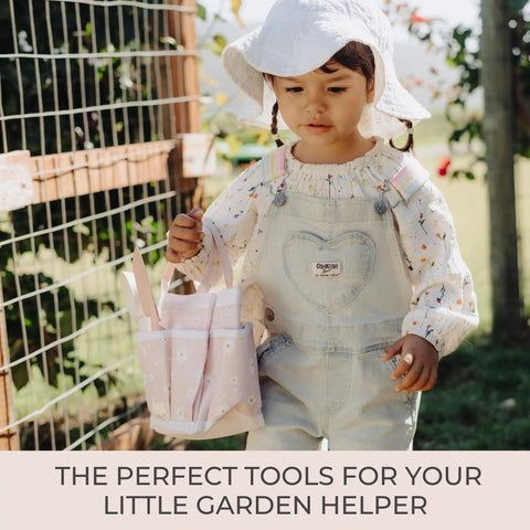 Child holding pink tote from Kid Friendly Garden Starter Kit With Durable Safe Tools For Outdoor Fun Including Gloves, Tote Bag, 22Oz Watering Can.