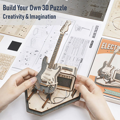 DIY Wooden Guitar Kit 3D Puzzle Craft Build Your Own Electric Guitar Model Easy Assembly In One And A Half Hours Totally Brain Teaser Toy Gift For Teens And Adults Creative Gift Idea For Makers And Collectors product on desk with instructions.