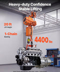 Built Tough Heavy Duty Electric Chain Hoist Up To 4400 Lbs With 20 Ft Lift Height in use lifting an engine in a workshop.