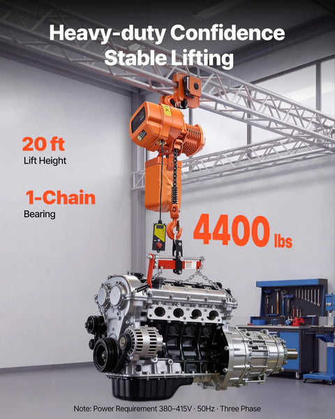 Built Tough Heavy Duty Electric Chain Hoist Up To 4400 Lbs With 20 Ft Lift Height in use lifting an engine in a workshop.