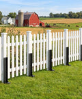 Heavy Duty Fence Post Repair Kit Featuring Rock Solid Steel Anchors and Beefy L Shaped Stakes for mailboxes and fences next to a white picket fence.