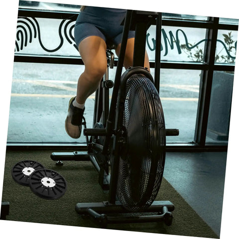 Person using exercise bike with Upgrade Your Home Gym With A Dope Heavy Duty Exercise Bike Belt Pulley Disc visible on right side.