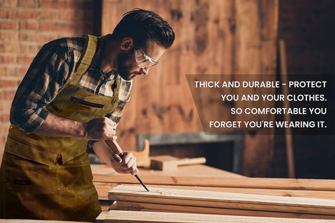 Kickass Heavy Duty Waxed Canvas Woodworking Apron For Men Featuring Boss Level Pocket Layout, worn by man chiseling wood.
