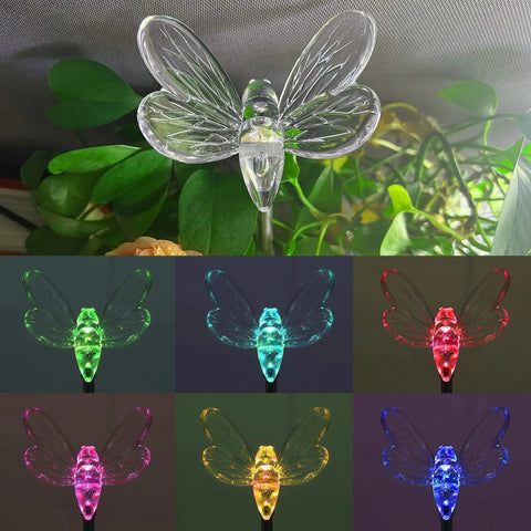 Six Pack Solar Garden Stake Lights Set With Color Changing LED Figurines Including Butterfly Dragonfly Hummingbird Bee Star Sunflower featuring a glowing dragonfly.