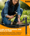 Person installing Heavy Duty One-Half Inch Irrigation Tubing Anchor Stakes Six Inch Long, 32-Pack For Securing Garden Hoses