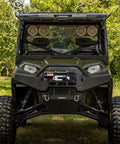 Heavy Duty 5500 Lb Electric Winch For Atv Utv With 12 Volt Motor and Waterproof Design mounted on ATV with mud tires.