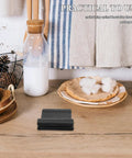 Steam Wand Safety Guard Heat Insulation Sleeve on kitchen counter in cozy setting, product for espresso machines, black rubber design