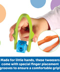 Child holding Easy-Grip Tweezers for Kids, featuring colorful sensory bin tools and comfortable finger placement grooves for toddlers.