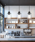 Black Pendant Lights For Kitchen Island, Modern Glass Hanging Fixture in a coffee shop setting with adjustable drop cord.