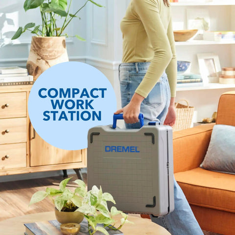 Person holding Portable Saw Station Kit with 12V Brushless Compact Circular Saw in a case for DIY projects, home setting.