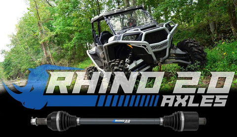 Beefed Up Rhino 2.0 Heavy Duty Rear Axles For Polaris RZR on display with off-road vehicle and logo