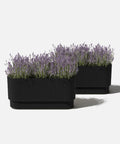 Long Planter For Porch Patio And Backyard In Durable Plastic Stone Composite Fluted All Weather Outdoor Pot For Shrubs And Flowers Modern Decor With Scratch And UV Resistant Finish displayed with plants.