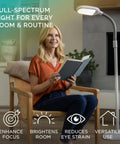 Lit Full Spectrum LED Floor Lamp With Adjustable Brightness And Flexible Gooseneck next to woman reading for eye strain relief
